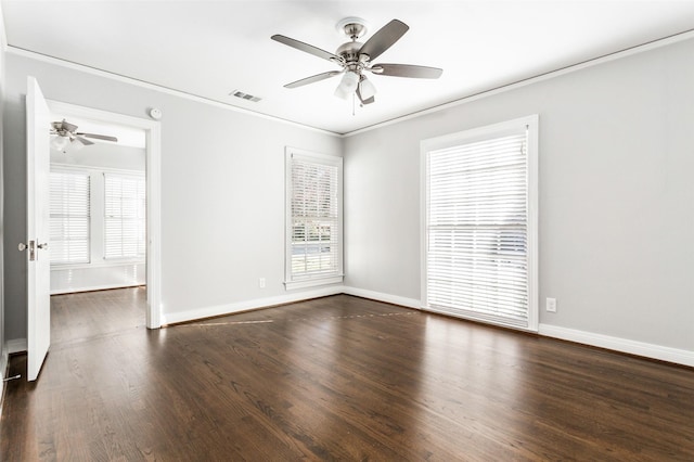 empty room featuring ceiling fan, dark hardwood / wood-style floors, and ornamental molding