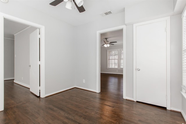 spare room featuring ceiling fan and dark hardwood / wood-style floors