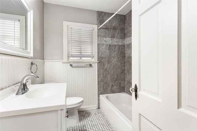 full bathroom featuring toilet, vanity, and tiled shower / bath