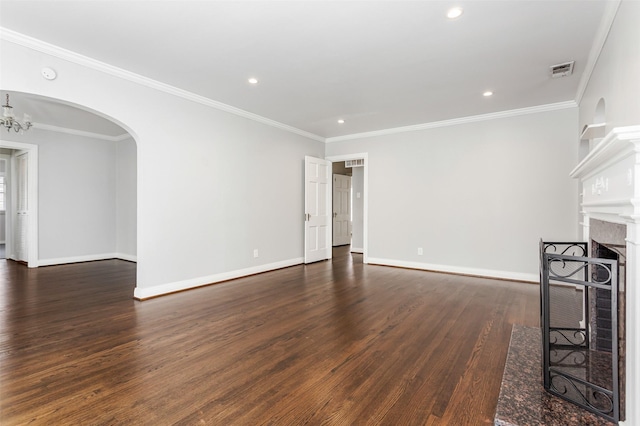 unfurnished living room featuring dark hardwood / wood-style flooring, ornamental molding, and a notable chandelier