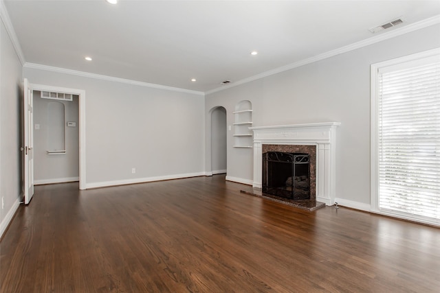 unfurnished living room featuring dark hardwood / wood-style flooring, crown molding, and a healthy amount of sunlight