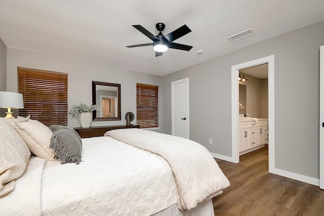 bedroom featuring ensuite bathroom, sink, ceiling fan, and dark hardwood / wood-style floors