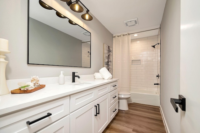 full bathroom featuring vanity, hardwood / wood-style floors, shower / bathtub combination with curtain, and toilet