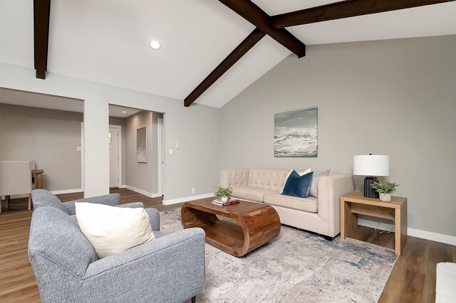 living room featuring hardwood / wood-style flooring and lofted ceiling with beams