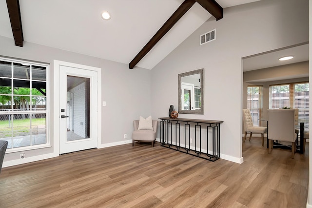 interior space featuring beamed ceiling, light hardwood / wood-style floors, and high vaulted ceiling