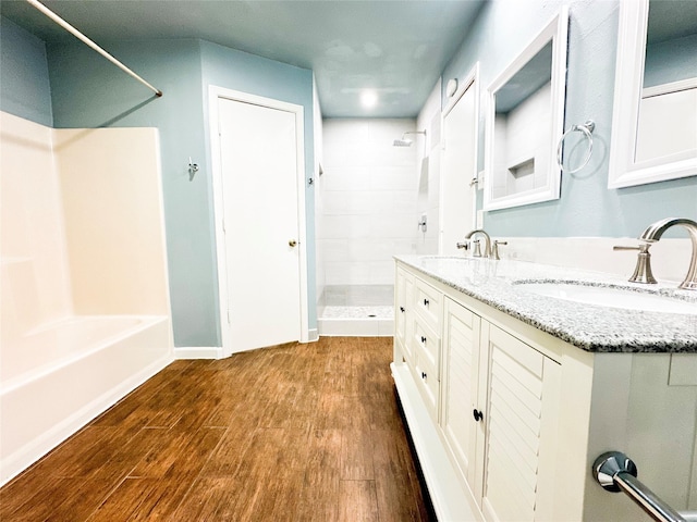 bathroom with vanity, wood-type flooring, and a shower