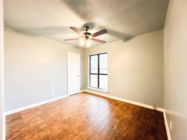 spare room with ceiling fan, hardwood / wood-style floors, and a textured ceiling