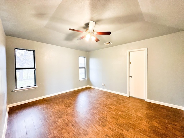 spare room featuring a textured ceiling, hardwood / wood-style flooring, ceiling fan, and lofted ceiling