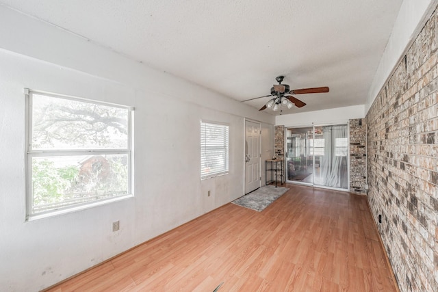 unfurnished living room featuring hardwood / wood-style flooring and ceiling fan