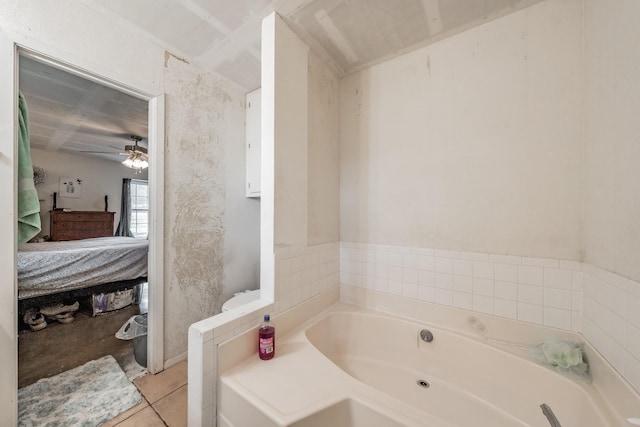 bathroom featuring tile patterned flooring, ceiling fan, and a bathing tub