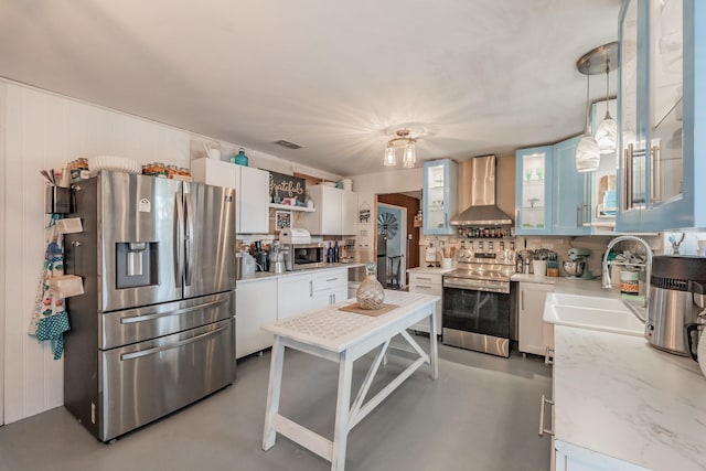 kitchen featuring white cabinetry, sink, wall chimney exhaust hood, stainless steel appliances, and backsplash