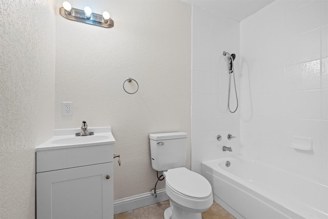 full bathroom featuring tile patterned flooring, vanity, tiled shower / bath, and toilet