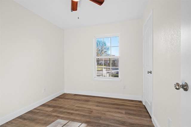 spare room featuring ceiling fan and dark hardwood / wood-style flooring