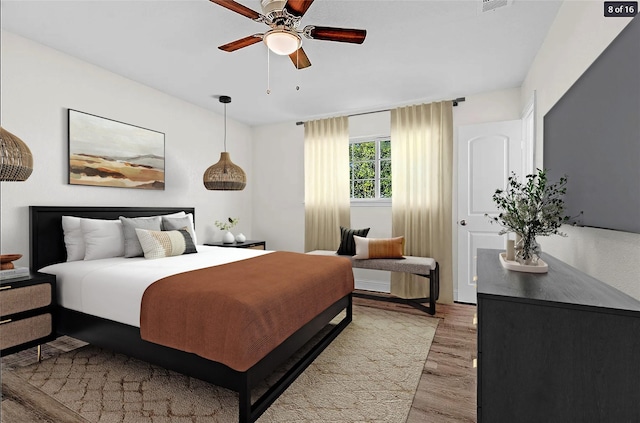 bedroom with light wood-type flooring and ceiling fan