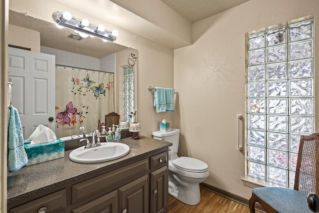 bathroom with vanity, hardwood / wood-style floors, a textured ceiling, and toilet