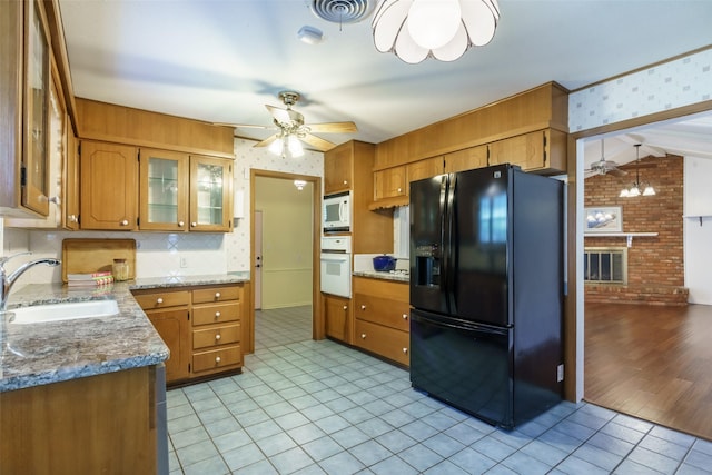 kitchen featuring white appliances, brick wall, decorative backsplash, sink, and ceiling fan