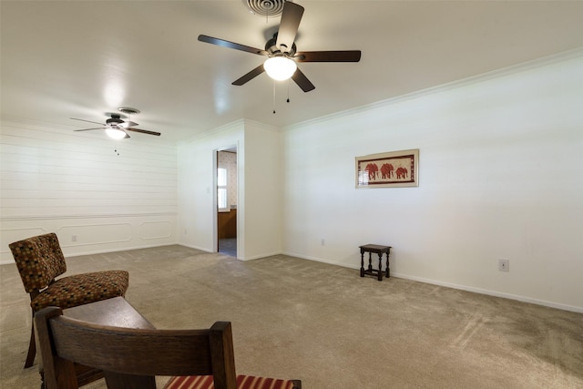 living area with light colored carpet, ceiling fan, and ornamental molding