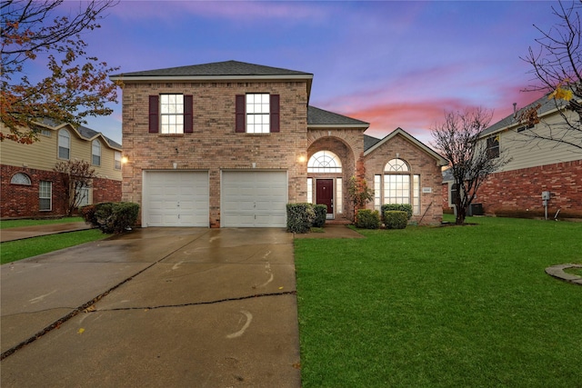 view of property with a yard and a garage