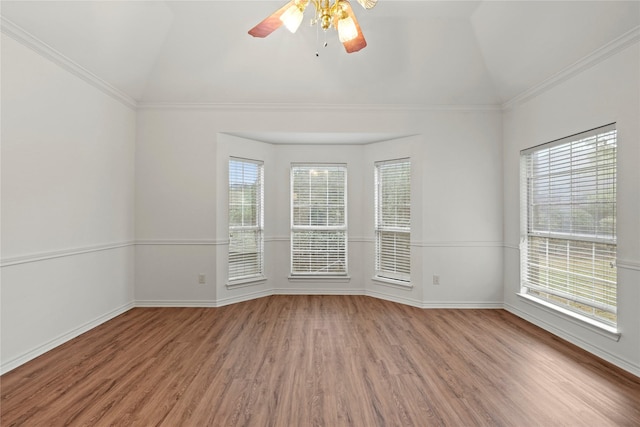 spare room featuring hardwood / wood-style flooring, ceiling fan, lofted ceiling, and crown molding