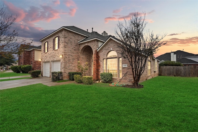 view of front facade featuring a garage and a yard