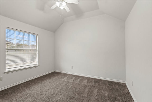 carpeted spare room featuring ceiling fan and vaulted ceiling