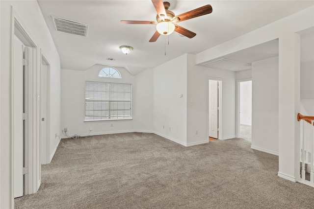 carpeted empty room with vaulted ceiling and ceiling fan