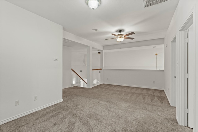 carpeted spare room with ceiling fan