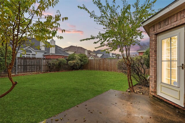 yard at dusk with a patio