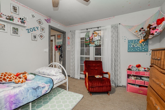 carpeted bedroom with ceiling fan, separate washer and dryer, and an AC wall unit