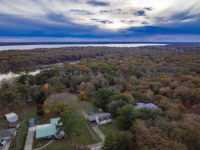 aerial view at dusk featuring a water view