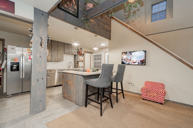 kitchen featuring hanging light fixtures, an AC wall unit, light stone countertops, electric range, and a kitchen island