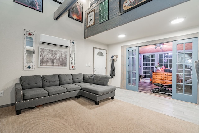 living room featuring an AC wall unit and a high ceiling