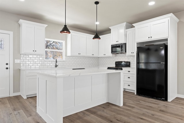 kitchen featuring white cabinetry, pendant lighting, a kitchen island, and black appliances