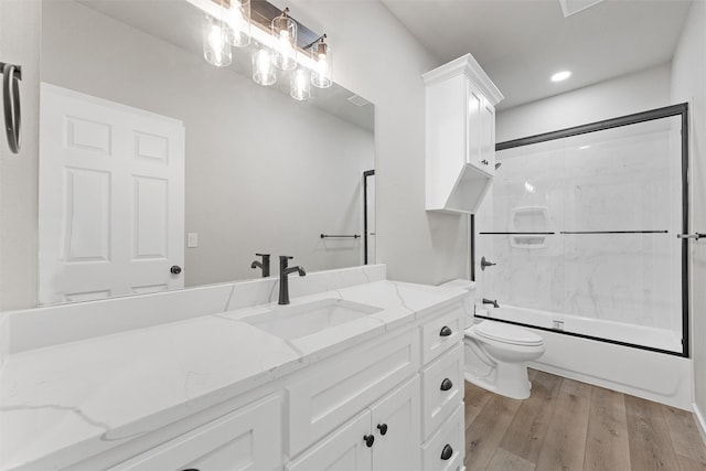 full bathroom with shower / bathing tub combination, vanity, hardwood / wood-style flooring, and toilet