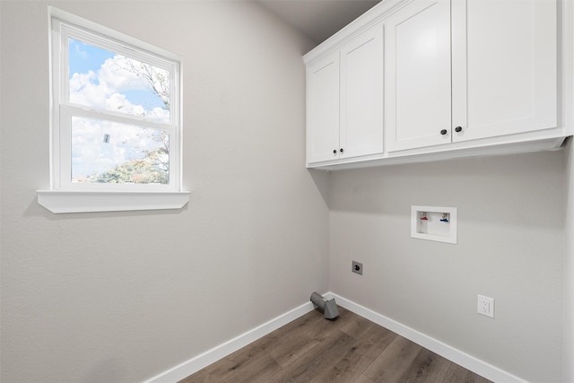 laundry area with electric dryer hookup, washer hookup, dark hardwood / wood-style flooring, and cabinets