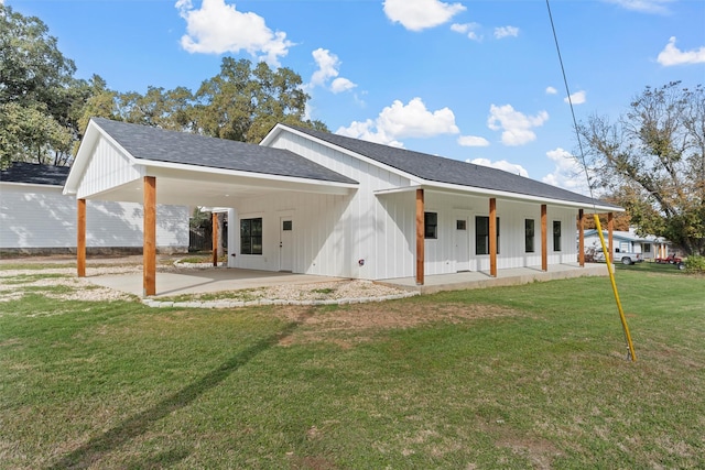 back of property featuring a lawn