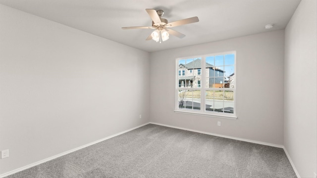 carpeted empty room featuring ceiling fan