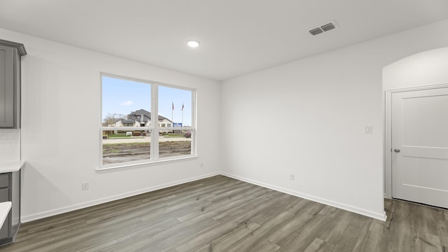 spare room featuring wood-type flooring