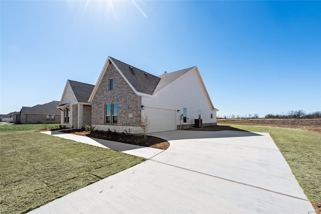 view of property exterior with brick siding, central air condition unit, a lawn, an attached garage, and driveway