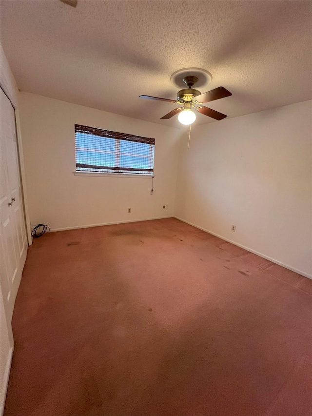 unfurnished bedroom with ceiling fan, carpet flooring, a closet, and a textured ceiling