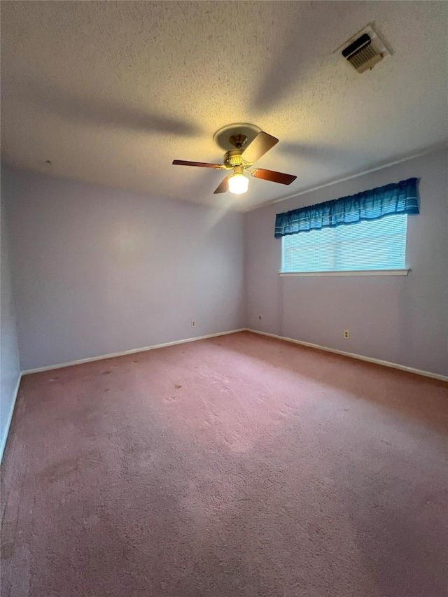 spare room featuring ceiling fan, carpet floors, and a textured ceiling