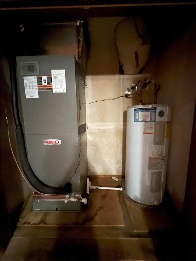 utility room featuring heating unit and water heater