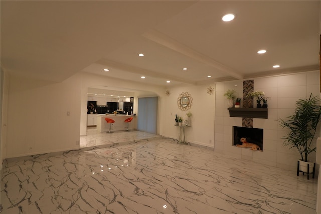 unfurnished living room featuring a tile fireplace