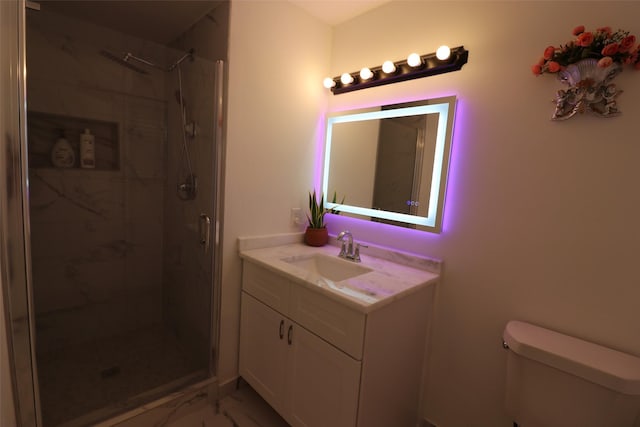 bathroom with vanity, toilet, and a shower with shower door