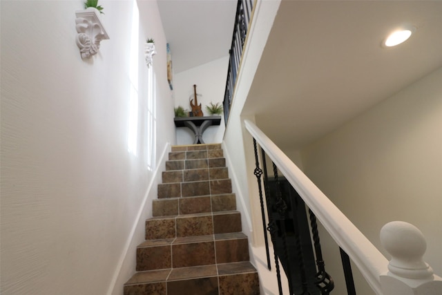 staircase featuring tile patterned floors