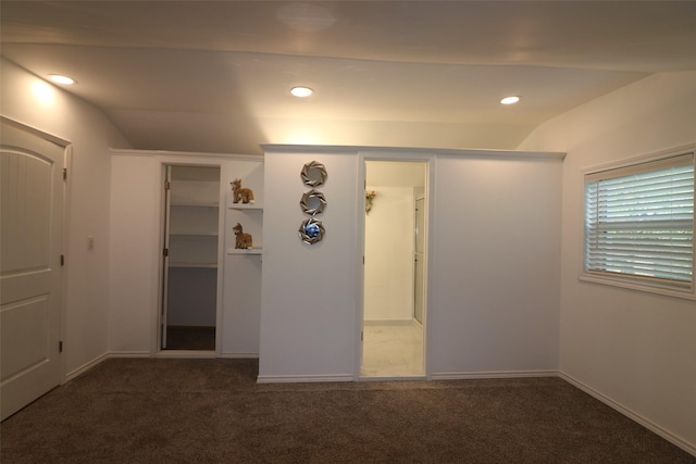 carpeted empty room with lofted ceiling