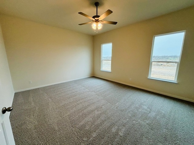 carpeted spare room featuring ceiling fan