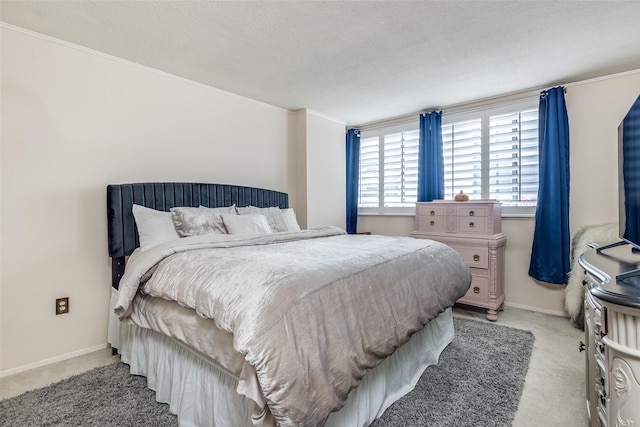 bedroom with a textured ceiling, light colored carpet, and crown molding