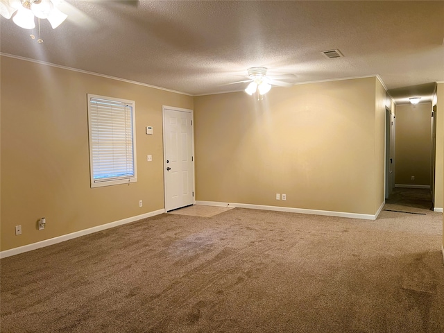 carpeted empty room featuring ornamental molding, a textured ceiling, and ceiling fan