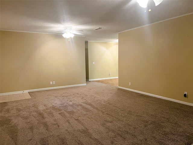 carpeted spare room with crown molding, ceiling fan, and a textured ceiling